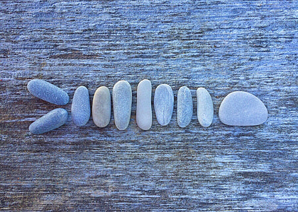 close up photo lined stones on brown surface thumbnail