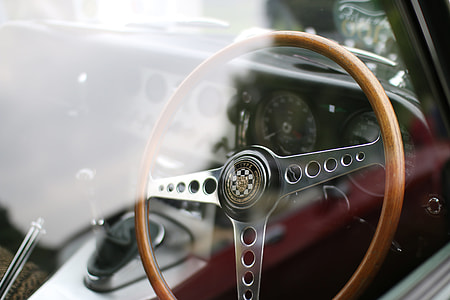closeup photography of gray and brown vehicle steering wheel in a closed car thumbnail