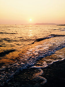 calm sea waves with sun at the horizon thumbnail