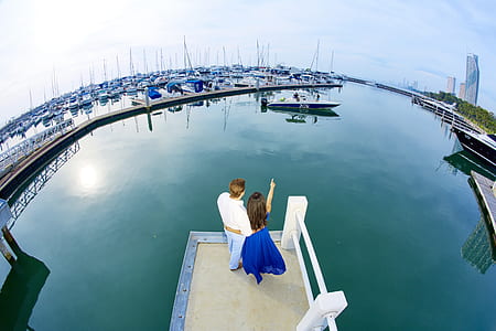 man and woman standing on boardwalk thumbnail