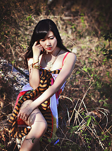 woman wearing red spaghetti strap dress in the forest thumbnail