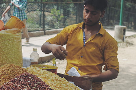 man holding paper standing near food cart thumbnail