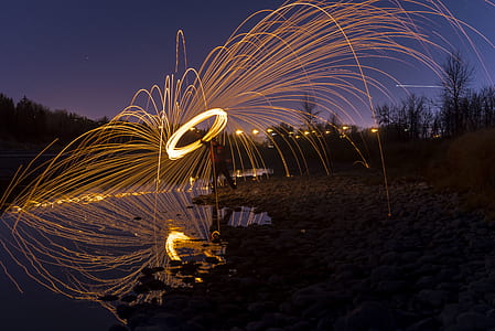 time lapse photography of person holding steel wool thumbnail