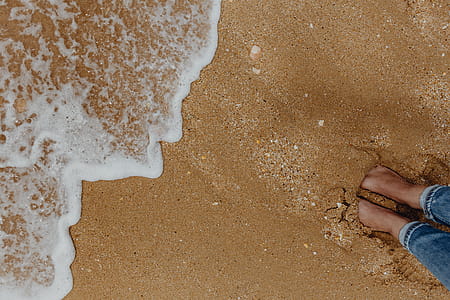 Sand beach background with sea shells & pebbles - many round small stones thumbnail