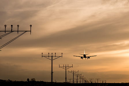 airliner on flight near utility posts thumbnail