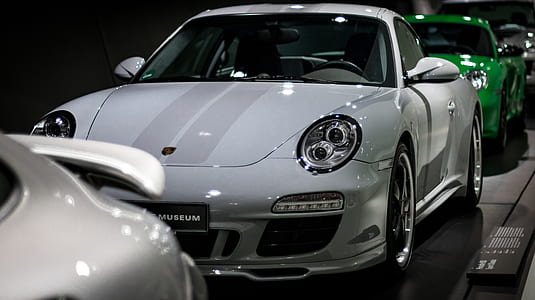 white car in front of green car thumbnail