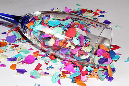 clear champagne glass surrounded with petals thumbnail