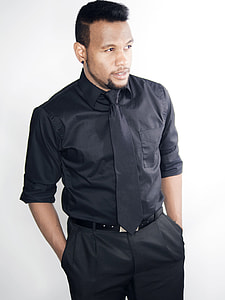man wearing black dress shirt and black bottoms thumbnail