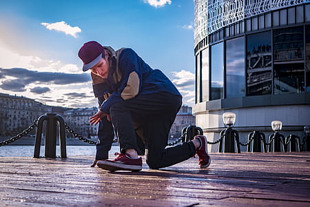 Person Kneeling With One Leg on Footbridge thumbnail