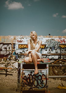 woman sitting on white and green wooden cabinet thumbnail