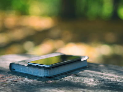 selective focus photography of post-2016 iPhone on book thumbnail