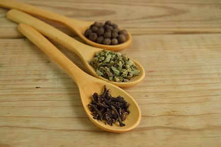 brown wooden ladles filled with herbs and spices thumbnail