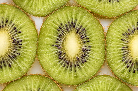 sliced kiwi fruits on whtie surface thumbnail
