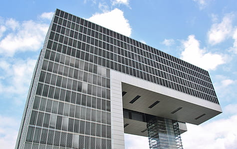 low angle photo of gray concrete buildings during daytime thumbnail