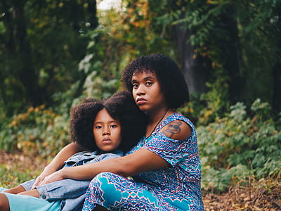 woman wearing blue dress hugging girl thumbnail