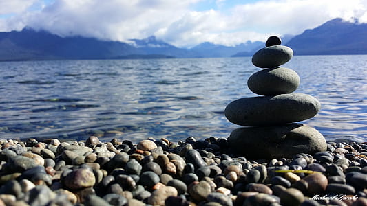 closeup photo of balance stones near body of water thumbnail