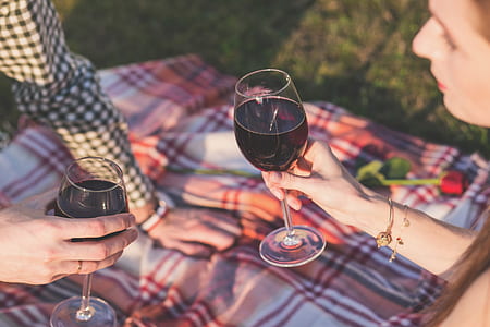 two people holding clear wine glasses during daytime thumbnail