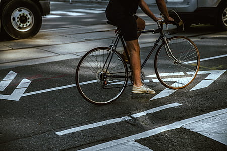 Man Riding In City Bike Lane Photo thumbnail