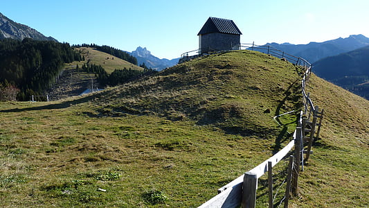 small gray house on top of hill thumbnail
