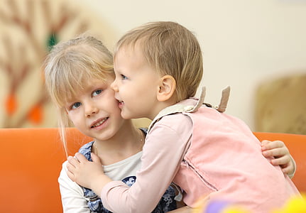 girl and toddler talking to each other thumbnail