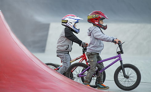 two boys riding bikes thumbnail
