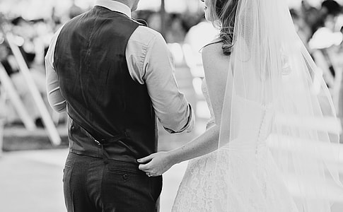 grayscale photography of couple in wedding dress and suit thumbnail