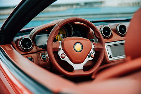 Side view of leather interior of a car with controls on the steering thumbnail