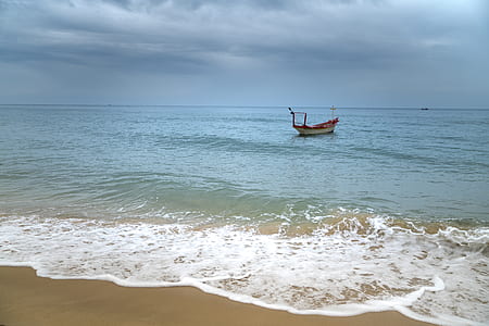 gray boat on sea shore thumbnail