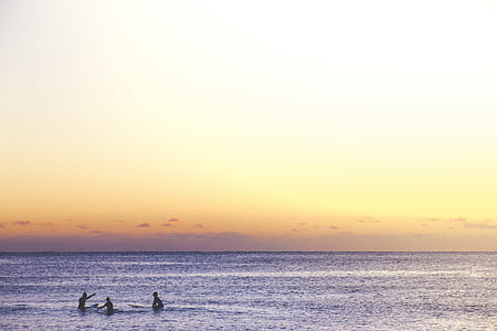 photo of three person swimming on sea thumbnail