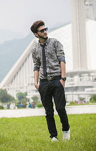man standing on grass field thumbnail