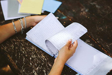 Woman reading a diary by the table thumbnail