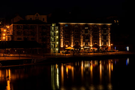 lighted concrete building near body of water thumbnail