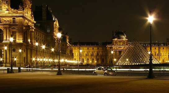 timelapse photography silver Volkswagen New beetle near Louvre Museum at night time thumbnail