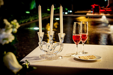 tilt-shift photography of candles and flute glasses thumbnail