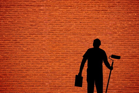 silhouette of a man holding paint roller thumbnail