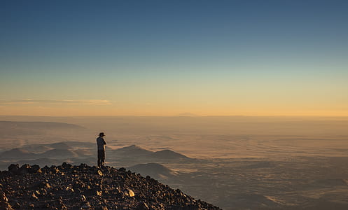 man standing at the top of the mountain thumbnail