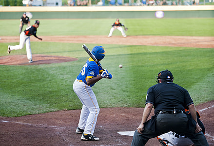 man holding baseball bat in front of pitcher thumbnail
