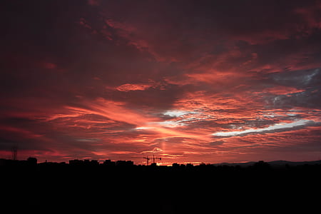 silhouette photograph of town during golden hour thumbnail