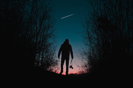 silhouette of man holding camera thumbnail