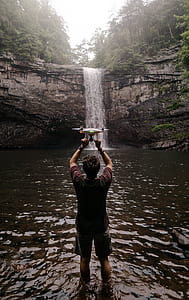 man using his white drone thumbnail