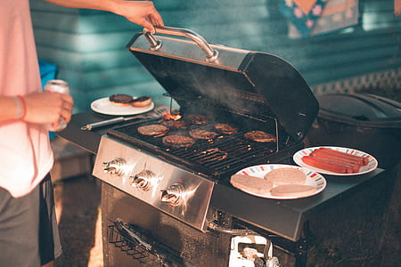 man holding gas grill thumbnail