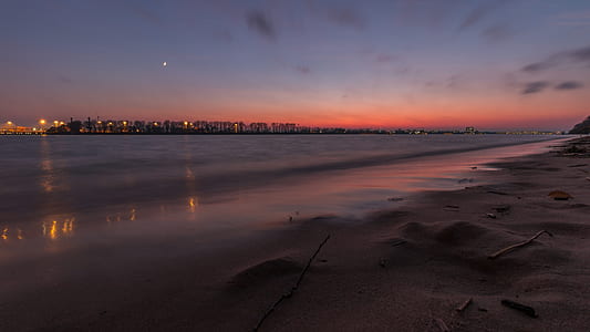 building near sea during blue hour thumbnail