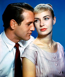 man beside woman standing near blue surface thumbnail