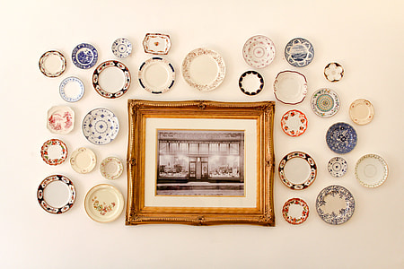 framed photo surrounded by plates thumbnail