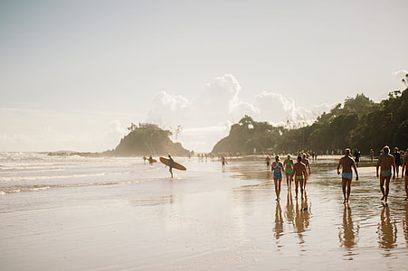 people gathered in a beach shore with rock formations thumbnail