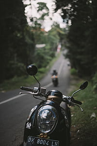 black motor scooter in shallow focus shot thumbnail