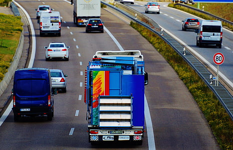 moving vehicles on road during daytime thumbnail