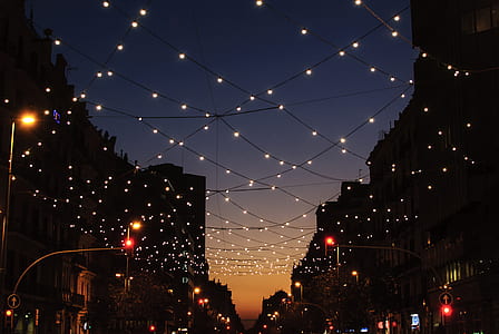 string lights hanging in between the buildings at night thumbnail