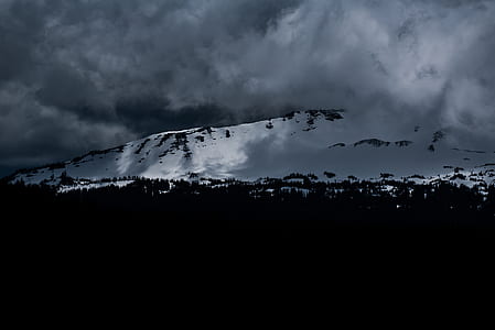mountain covered with snow under white sky thumbnail