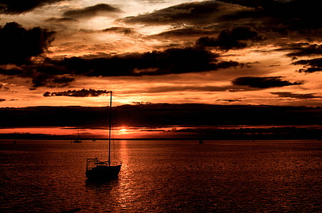 silhouette of sailboat under black sky thumbnail